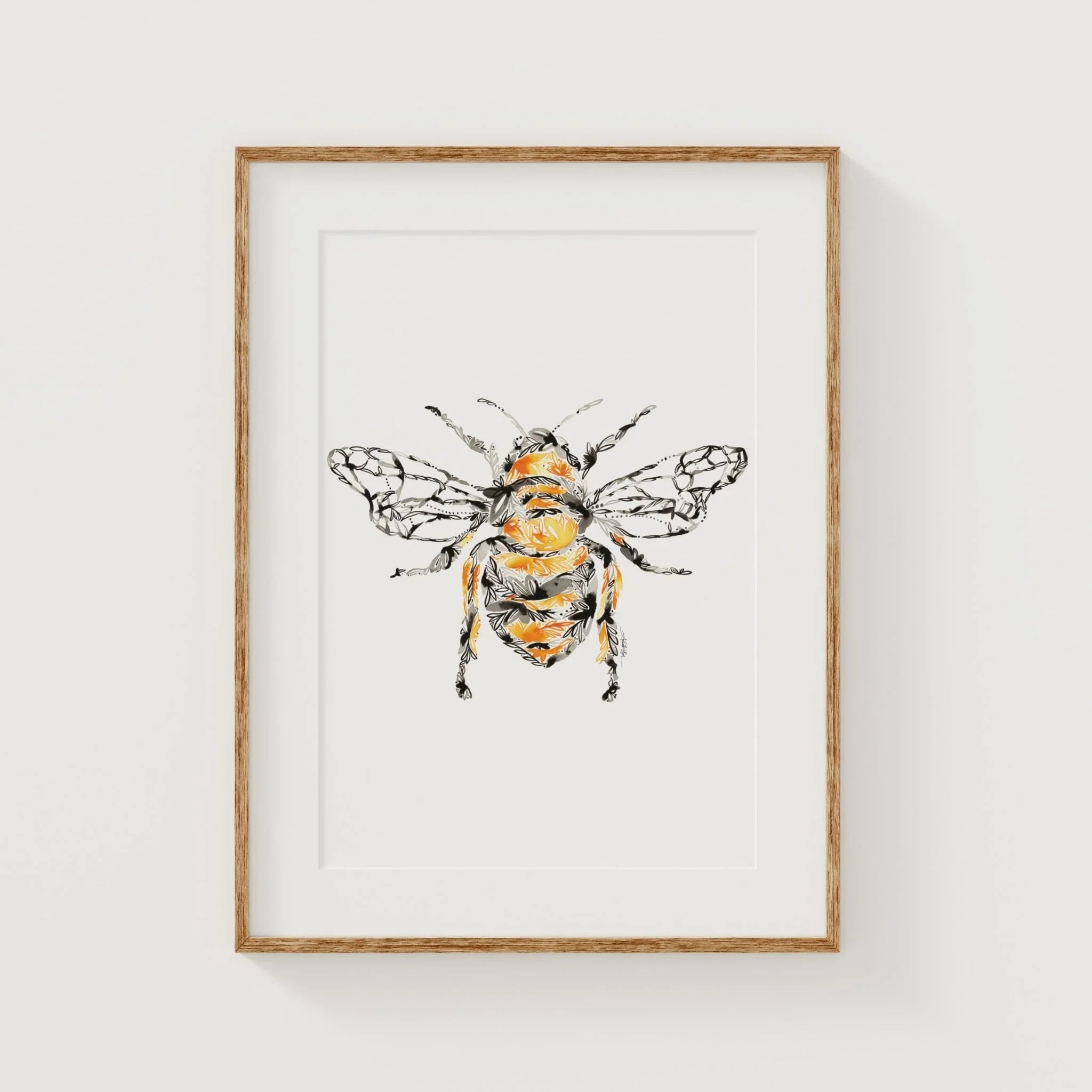 Framed honey bee art print with floral pattern, yellow and black, in light wood frame for wall decor