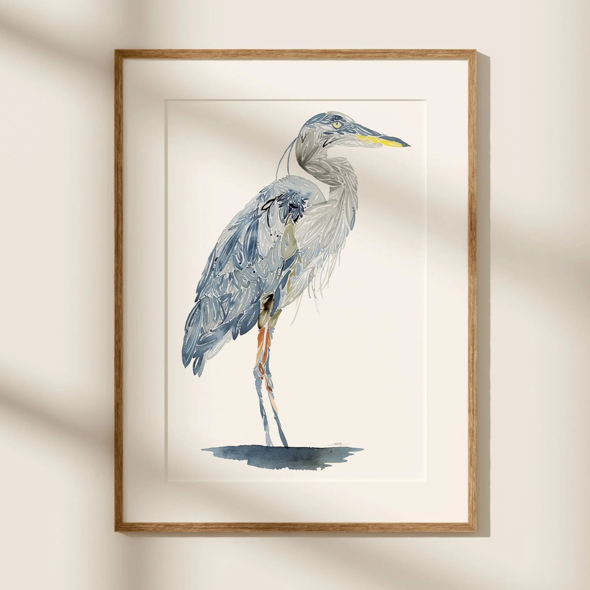 Framed Blue heron watercolor art print with blue-gray feathers and yellow beak